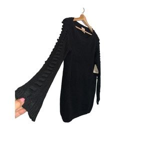 Black knit pull over top with cross cross design on sleeves